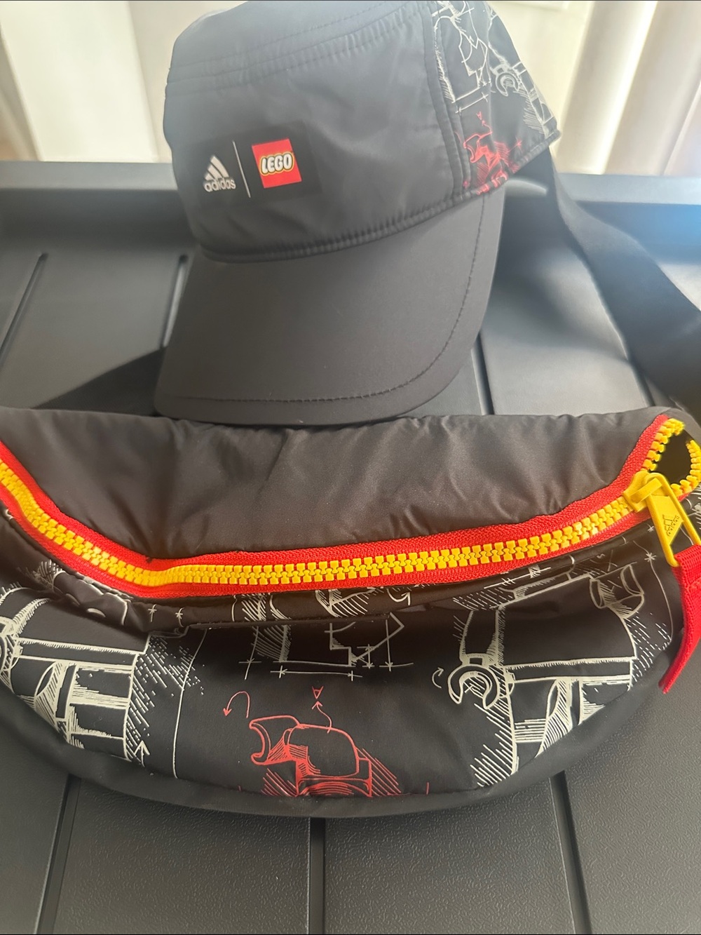 adidas Black Cap and Printed Waist Bag with Red & Yellow Accents